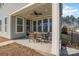 Relaxing covered patio featuring an outdoor dining set and ample natural light at 630 Daventry Ct, Clover, SC 29710