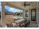 Inviting covered patio area with a ceiling fan and a view of the sparkling backyard pool at 630 Daventry Ct, Clover, SC 29710