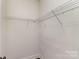 Minimalist walk-in closet with white walls and wire shelving for organized storage at 630 Daventry Ct, Clover, SC 29710
