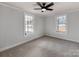 Bright bedroom with carpet flooring and two windows at 701 Hiddenite Church Rd, Hiddenite, NC 28636