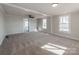 Bright living room with new carpet and ceiling fan at 701 Hiddenite Church Rd, Hiddenite, NC 28636