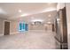 Spacious basement with marble floors, kitchenette, and access to patio at 720 Ideal Way, Charlotte, NC 28209