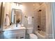 Clean bathroom with white vanity, bathtub, and shower at 720 Ideal Way, Charlotte, NC 28209