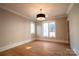 Light-filled bedroom with hardwood floors and crown molding at 720 Ideal Way, Charlotte, NC 28209