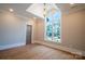 Bedroom with hardwood floors, large window, and tray ceiling at 720 Ideal Way, Charlotte, NC 28209