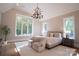 Bright and airy primary bedroom with large windows and a comfortable sitting area at 720 Ideal Way, Charlotte, NC 28209