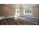 Bright bonus room with hardwood floors, sliding glass doors, and chandelier at 720 Ideal Way, Charlotte, NC 28209