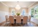 Formal dining room with a chandelier, large windows, and seating for six at 720 Ideal Way, Charlotte, NC 28209