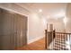 Upstairs hallway with hardwood floors and neutral walls at 720 Ideal Way, Charlotte, NC 28209