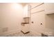 Bright laundry room with white cabinets and a farmhouse sink at 720 Ideal Way, Charlotte, NC 28209