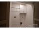 Bright laundry room with white cabinets and patterned tile floor at 720 Ideal Way, Charlotte, NC 28209