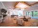Open living room with exposed beams, large windows, and access to patio at 720 Ideal Way, Charlotte, NC 28209