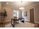 Elegant home office featuring a wooden desk and modern light fixture at 720 Ideal Way, Charlotte, NC 28209
