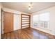 Bedroom with wood floors, built-in shelves, and large windows at 748 Skinner Rd, Shelby, NC 28152