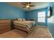 Light blue bedroom with ceiling fan and wood dresser at 867 Pecan Tree Ln, Fort Mill, SC 29715