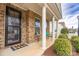 Covered porch with columns, seating, and landscaping at 867 Pecan Tree Ln, Fort Mill, SC 29715