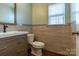 Small powder room with light green walls and tile flooring at 867 Pecan Tree Ln, Fort Mill, SC 29715