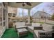 Relaxing screened porch with wicker furniture and green carpet at 867 Pecan Tree Ln, Fort Mill, SC 29715