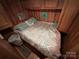 Main bedroom with wood walls and built-in storage at 105 Richard Dr, New London, NC 28127
