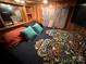 Main bedroom with wood walls and patterned bedding at 105 Richard Dr, New London, NC 28127