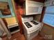 Cozy kitchen with stove, microwave, and refrigerator at 105 Richard Dr, New London, NC 28127