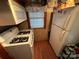 Small kitchen featuring white appliances and wood floors at 105 Richard Dr, New London, NC 28127