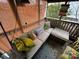 Screened porch with wicker sofa and tropical pillows at 105 Richard Dr, New London, NC 28127
