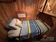 Cozy small bedroom with wood walls and a twin-size bed at 105 Richard Dr, New London, NC 28127