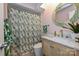 Bright bathroom featuring a shower with a leaf-patterned curtain and a stylish vanity at 1077 Sardis Cove Dr, Charlotte, NC 28270