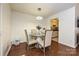 Bright dining area with modern light fixture, seating for four, and view to kitchen at 1077 Sardis Cove Dr, Charlotte, NC 28270