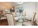 Cozy dining room with glass table, brick fireplace and sliding door to the outside at 1077 Sardis Cove Dr, Charlotte, NC 28270