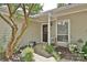Inviting front porch with decorative plants, a stylish wreath, and outdoor seating at 1077 Sardis Cove Dr, Charlotte, NC 28270