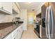 Clean kitchen featuring granite counters, white cabinets, stainless steel appliances, and tile floors at 1077 Sardis Cove Dr, Charlotte, NC 28270