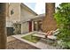 Charming patio with outdoor seating, lush landscaping, and an eye-catching brick fireplace at 1077 Sardis Cove Dr, Charlotte, NC 28270