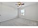 Bright bedroom with carpet, ceiling fan, and large window at 1104 Less Traveled Trl, Indian Trail, NC 28079