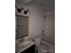 Bright bathroom featuring a vanity, toilet, and a shower-tub combo with white tile surround at 11041 Cedar View Rd, Charlotte, NC 28226