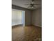 A cozy bedroom is filled with natural light from a large window, complemented by sleek ceiling fan at 11041 Cedar View Rd, Charlotte, NC 28226