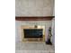 A marble fireplace with a brown wood mantel and glass doors at 11041 Cedar View Rd, Charlotte, NC 28226