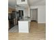 Bright kitchen area featuring wood floors, stainless steel refrigerator, and an adjacent dining area at 11041 Cedar View Rd, Charlotte, NC 28226