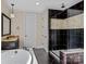 Spa-like bathroom with soaking tub, walk-in shower, and dark tile at 11052 Preservation Park Dr, Charlotte, NC 28214