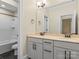 Modern bathroom featuring a double vanity with marble countertop and bathtub with tiled surround at 11052 Preservation Park Dr, Charlotte, NC 28214