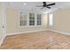 Bright bedroom with hardwood floors, plantation shutters, and ceiling fan at 11052 Preservation Park Dr, Charlotte, NC 28214