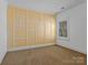 Neutral bedroom featuring geometric wall paneling and natural light at 11052 Preservation Park Dr, Charlotte, NC 28214