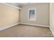 Cozy bedroom with plush carpeting, neutral walls, and a window with shutter style shades at 11052 Preservation Park Dr, Charlotte, NC 28214