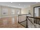 Open bonus room featuring hardwood floors and plenty of natural light at 11052 Preservation Park Dr, Charlotte, NC 28214