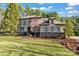 Charming two-story home with stone accents, manicured lawn, and lush landscaping at 11052 Preservation Park Dr, Charlotte, NC 28214