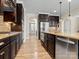 Open kitchen with island, stainless steel appliances, and hardwood floors at 11052 Preservation Park Dr, Charlotte, NC 28214