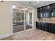 Kitchen features dark cabinetry, granite countertops, and sliding glass doors to deck at 11052 Preservation Park Dr, Charlotte, NC 28214