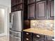 Stainless steel refrigerator with granite countertops and dark wood cabinets at 11052 Preservation Park Dr, Charlotte, NC 28214
