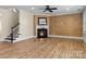 Living room with fireplace, hardwood floors and built-in shelving at 11052 Preservation Park Dr, Charlotte, NC 28214